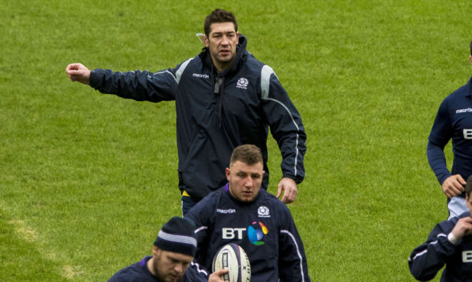 Assistant coach Nathan Hines calls the shots at yesterday's captain's run at Murrayfield.