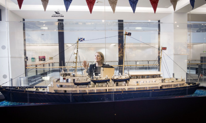 Royal Yacht Britannia employee Emma Aitken looks at the Lego model.