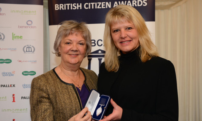 Dame Mary Perkins, left, Specsavers co-founder and patron of the British Citizen Awards, presents the award to Perth teacher Ali Kinge.