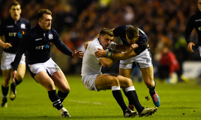 Tommy Seymour and Stuart Hogg catch George Ford in possession in the Calcutta Cup match.