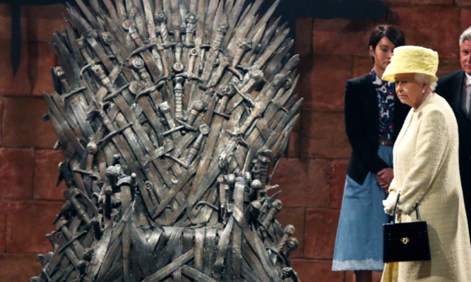 Queen Elizabeth views The Iron Throne