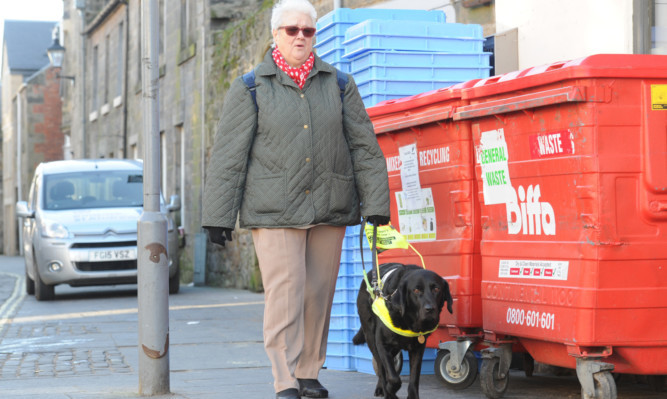 Catherine Rowe and her guide dog Aysha negotiate Market Street in St Andrews