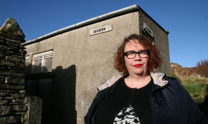 Hayley Green outside the former public toilet which is for sale on Orkney.