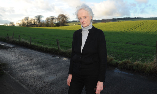 Sue Wilson is one of the objectors to the proposed housing development on the farmland in the background.