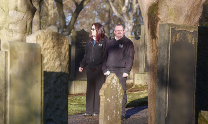 Safer communities officers Cat Linton and Frank Davis on patrol in Dunfermline Cemetery.