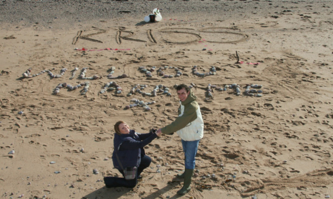 Mary gets down one one knee to pop the question.