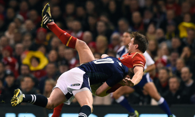 Finn Russell puts in a big hit on opposite number Dan Biggar in Saturday's 6 Nations match in Cardiff.