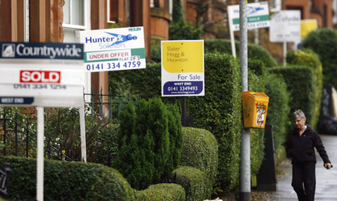 LONDON - DECEMBER 06:  Estate agent billboards in the West End of Glasgow December 6, 2007 in Glasgow,Scotland.The British economy is beginning to feel the effects of the credit crisis which began this year. House prices have begun to fall and the retail sector is predicting a difficult Christmas period.  (Photo by Jeff J Mitchell/Getty Images)