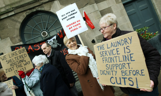 Pensioners protested outside the Town & County Hall in Forfar against cuts to TSOs.