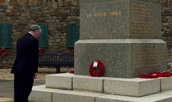 Defence Secretary Michael Fallon at the Liberation monument in Stanley.
