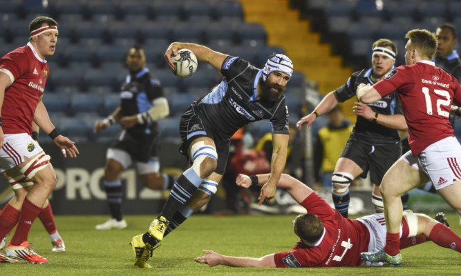 Josh Strauss charges through for Glasgow against Munster.