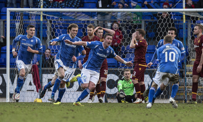 Tam Scobbie (centre) charges off to celebrate his late winner.