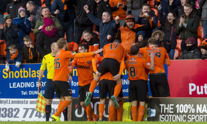 United's players unite with fans to celebrate Paul Paton's winner.