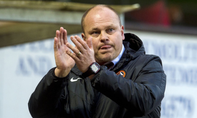 Mixu Paatelainen applauds the home fans at full-time.