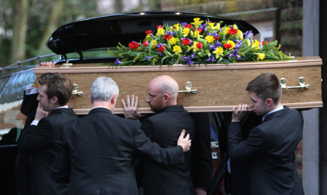 Pall-bearers carry Mr Gourlays coffin at Kirkcaldy Crematorium.