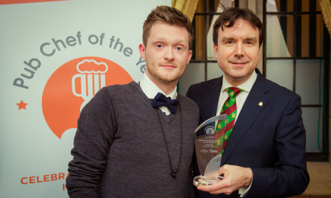 Dundee chef Robert Yuill accepts his Young Pub Chef of the Year award from Andrew Griffiths MP, Chair of the All Party Parliamentary Beer Group.