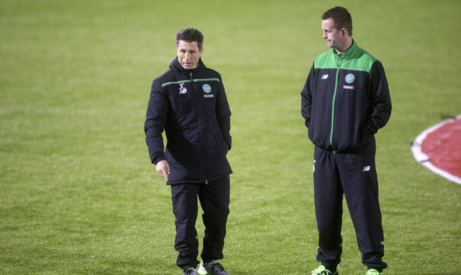 Celtic manager Ronny Deila (right) and assistant John Collins inspect the plastic pitch at New Douglas Park.