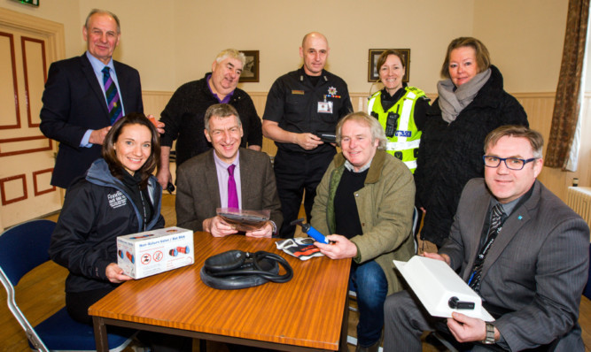 Councillor Mike Williamson, front centre left, with Peter Guinan, from Mill of Logierait Farm, and emergency services representatives at the meeting in Pitlochry Town Hall.