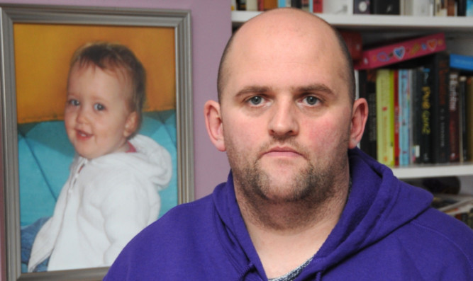 Alan Glynn beside a photo of daughter Alexis Rose.