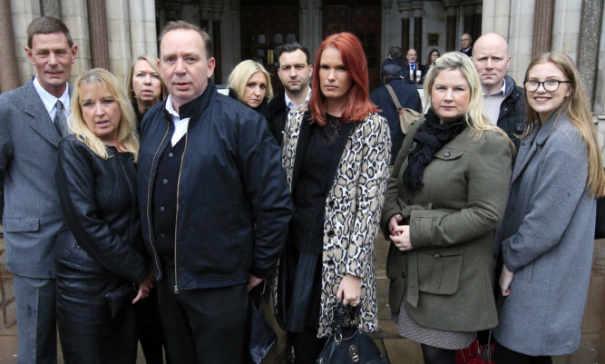 Some of the families of those who were killed by gunman Seifeddine Yacoubi at the Port El Kantaoui resort near Sousse in Tunisia, attend a pre-inquest hearing at the Royal Courts of Justice in London.