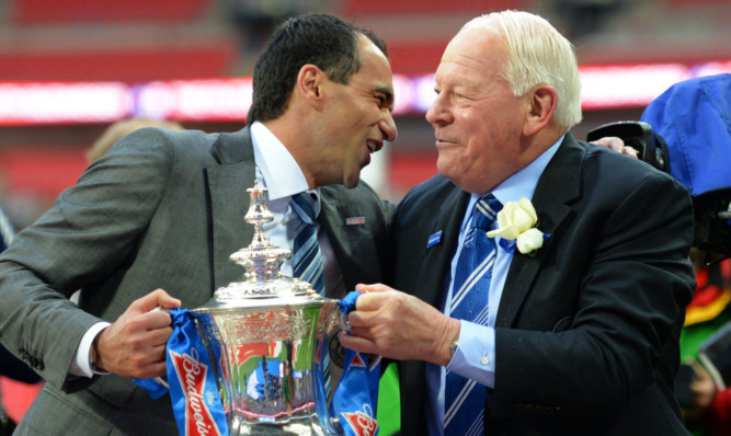 Wigan boss Roberto Martinez and chairman Dave Whelan get their hands on the FA Cup.