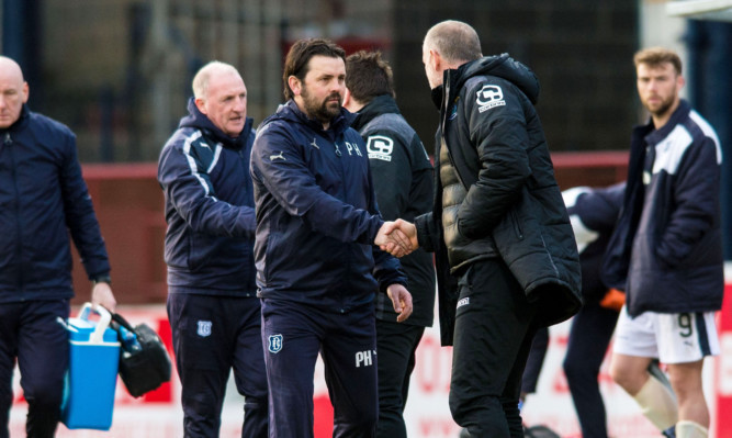 Paul Hartley shakes hands with Inverness CT manager John Hughes.