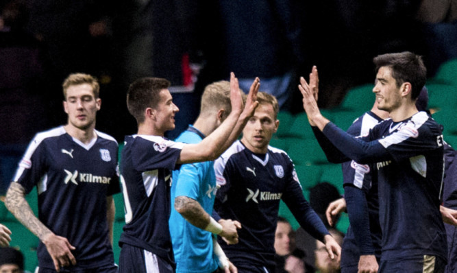 Dundee players celebrate a job well done at Parkhead.