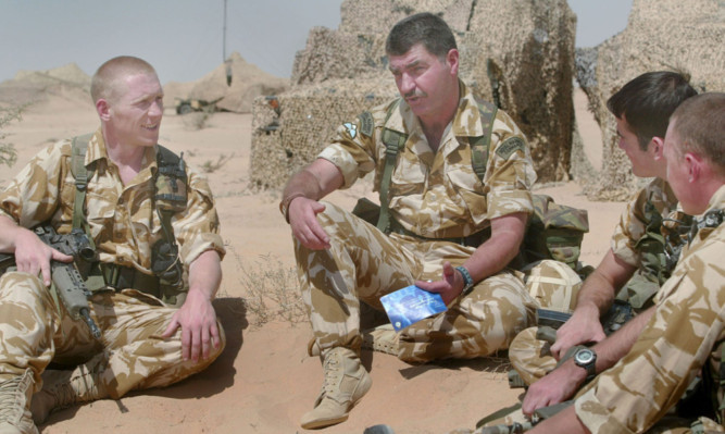 Corps trauma manager WO 1st Class Kevin Green, second left, talks to marines, from left, L/Cpl Matthew Martin, L/Cpl Steve Burns and L/Cpl Neil Fellows.