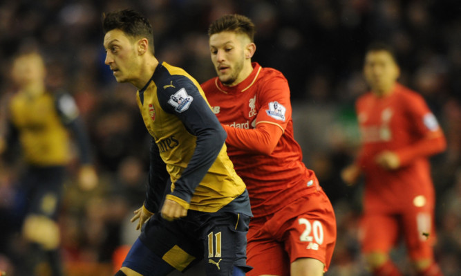 Mesut Ozil of Arsenal breaks past Liverpools Adam Lallana.The pair could be facing each other in a breakaway closed shop if talks reach fruition.