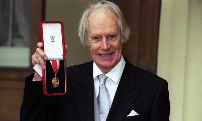 George Martin receiving his knighthood in 1996.