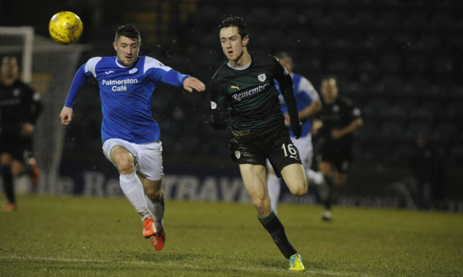 Raith dangerman Ryan Hardie tests the pace of Queens Lewis Kidd.