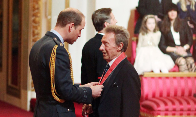 Former Scotland and Manchester United football great Denis Law is made a Commander of the Order of the British Empire by the Duke of Cambridge.