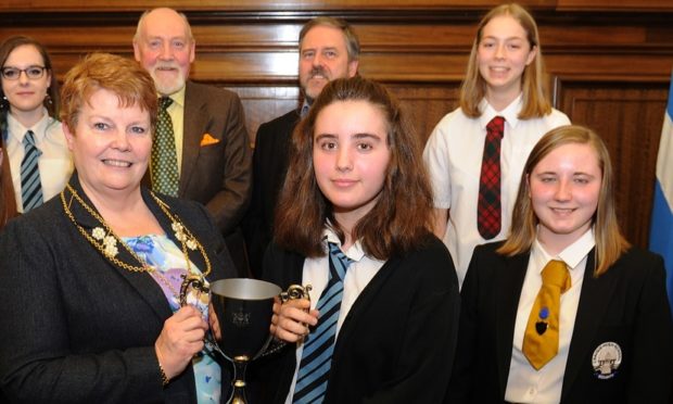 Pictured in the City Chambers, Dundee is The City of Dundee Burgess Charity Short Story Competition back l to r - Cara Kidd, Dr Alastair Ross, Gary Langlands, Rose Porteous and Holly Dunbar - front - depute provost Christina Roberts and winner Amy MacLeod with her trophy