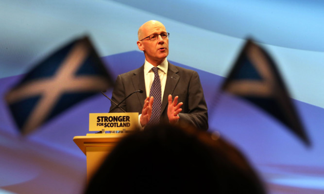 Deputy First Minister John Swinney speaks at the SNP spring conference at the SECC in Glasgow.