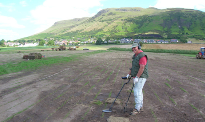 Jim Crombie with his metal detector on the banks of Loch Leven.