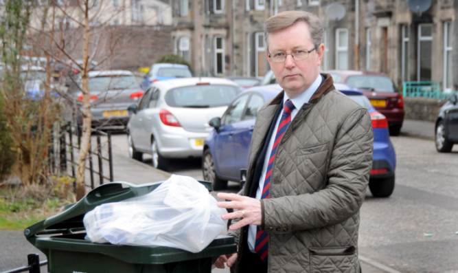 Councillor Alexander Stewart with one of the new style bins.