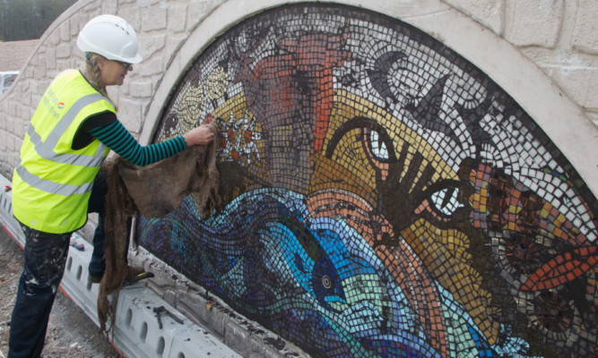 Artist Maureen Crosbie working on one of the five planned mosaics.