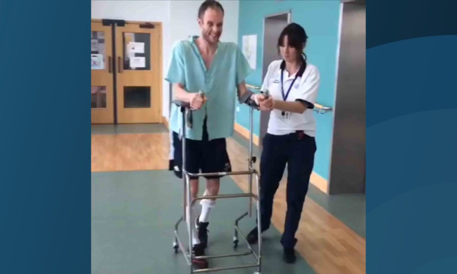 David takes his first tentative steps in hospital.