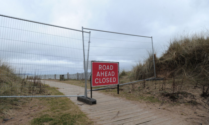 Effects of the tide are taking their toll on the wooden boardwalk.