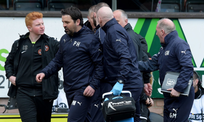 Paul Hartley heads for the tunnel after some angry exchanges with United's backroom staff.