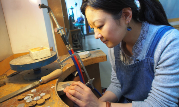 Duncan of Jordanstone graduate Sayoko Kobayashi working on one of her designs.