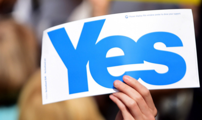 GLASGOW, SCOTLAND - SEPTEMBER 11:  Yes supporters hold placards as they disrupt an event attended by Leader of the Labour Party Ed Miliband (not seen) who was joined by MPs and councillors who travelled north to Glasgow for a day's campaigning in support of the no vote in the Scottish Referendum on September 11, 2014 in Glasgow, Scotland. Around 60 MP's and councillors left London Euston on a train at 7:30am to campaign against the breakup of the union just seven days before the people of Scotland head to the polls to vote ''Yes'' or ''No'' on whether Scotland should become an independent country.  (Photo by Jeff J Mitchell/Getty Images)