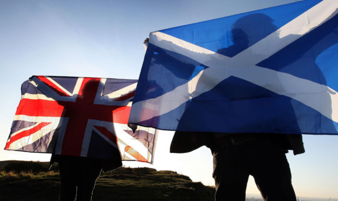 Two flags intertwined: the Union and Saltire fly in unison.