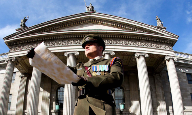 Captain Peter Kelleher from the 27th Infantry Battalion reads the Proclamation at the GPO on OConnell Street, Dublin,4 yesterday during the commemoration of the Easter Rising of 1916.