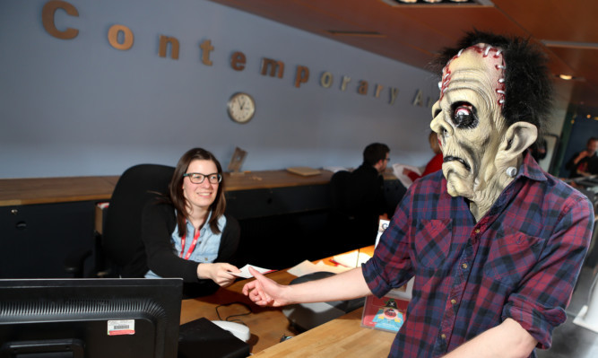 Frankenstein's monster buying tickets for one of the screenings from Chloe Milne.