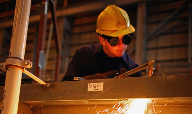 An apprentice steel fabricator learns his trade. The TUC said that if the Government wants to attract more young people into apprenticeships, it needs to up the £3.40 rate.