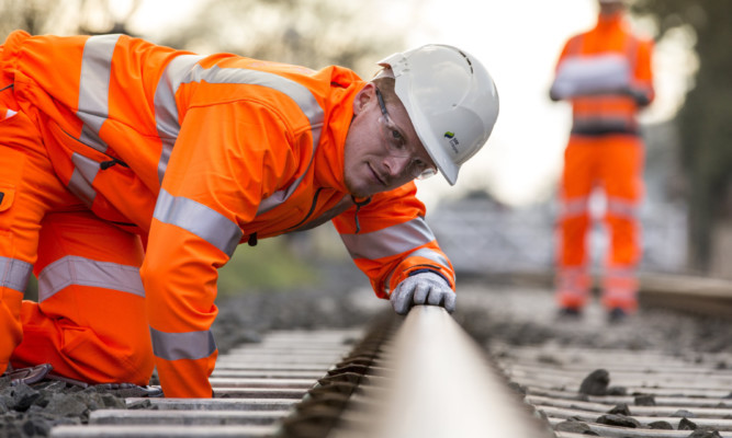 On track: an SSE Enterprise Rail engineer checks a line.