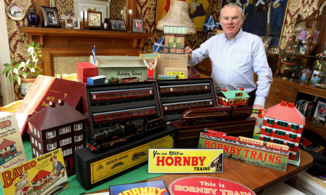 Event organsier Dale Smith with some of the model railway items that will feature at the exhibition.