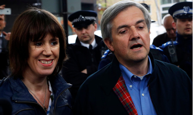 Chris Huhne faces the media with his partner Carina Trimingham after being released from prison.