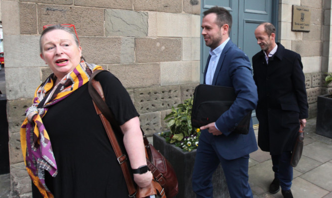 Festival of House licensing lawyer Janet Hood and festival organisers Craig Blyth and Stuart Hutton leave the Town and County Hall in Forfar.